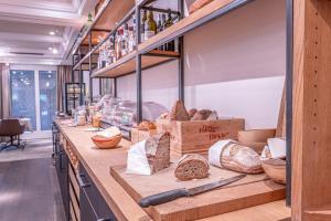 a bakery counter with breads and other food items at Landhotel Hirschen Swiss Quality in Aarau