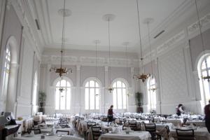 a large dining room with white tables and chairs at Hotel Parque Balneario Termas Pallares in Alhama de Aragón