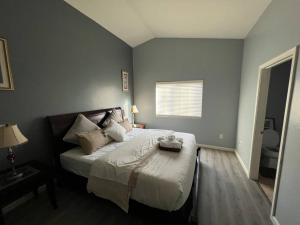 a bedroom with a large bed with white sheets and pillows at Lady T’s Serenity Getaway near TUS airport in Tucson