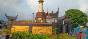 a building in front of a temple with a tower at PONDOK SITI RAWIYAH in Bukittinggi