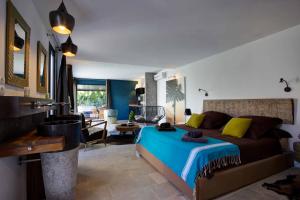 a bedroom with a bed and a living room at Villa Ha Taew in Sant Josep de sa Talaia