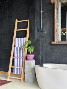 a bathroom with a ladder and a bath tub and a plant at Superior Mountain View Room in Weligama