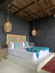 a bedroom with a large bed and two pendant lights at Superior Mountain View Room in Weligama