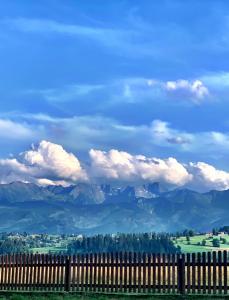 a fence with a view of the mountains at Mountain cozy house in Tatras in Ząb