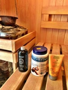 a wooden bench in a sauna with a bottle of medicine at Mountain cozy house in Tatras in Ząb