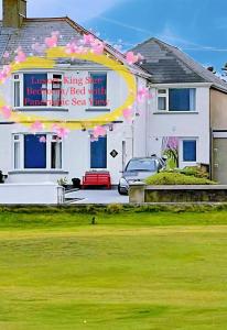 a house with a sign on the front of it at NUMBER 5 Portrush Road, Portstewart in Portstewart