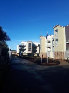 an empty street in front of a apartment building at Apartments in Phillip Island Towers - Block C in Cowes