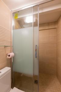 a shower with a glass door in a bathroom at Loft Latin in Paris