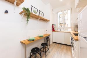 a small kitchen with a counter and stools at Loft Latin in Paris