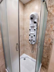 a shower stall with a glass shower door at Апартаменти за гости Делукс in Burgas City