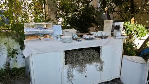 a white table with food on top of it at Hotel Golfo Azzurro in Capoliveri