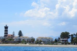 a view of a beach with a lighthouse in the distance at Marea in Messina