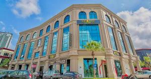 a large building with blue windows on a city street at Geobay Hotel in Johor Bahru