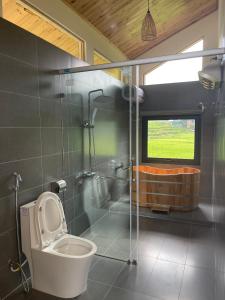 ein Bad mit einem WC, einer Dusche und einem Fenster in der Unterkunft Chapa Stream House in Sa Pa