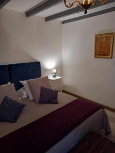 ein Schlafzimmer mit einem Bett mit Kissen und einer Lampe in der Unterkunft MONTISMAURELLI in Montmoreau