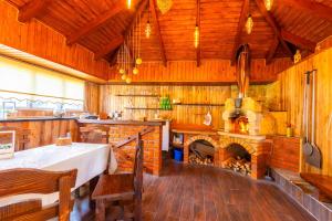 a dining room with a table and a fireplace at У Румуна in Yasinya