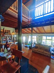 a living room with a person sitting at a table at The Goat and Goose Bed & Breakfast in Lakes Entrance