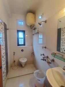 Hotel Swastik Regency في سيليغري: حمام مع مرحاض ومغسلة