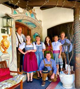 a group of people posing for a picture in a house at Hotel Bergland in Grainau
