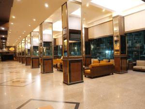 a lobby with couches and tables in a building at Boutique City Hotel in Pattaya South