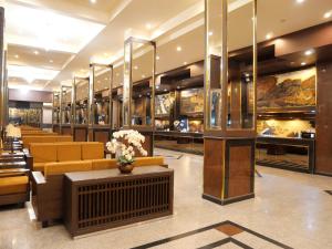 a lobby with couches and tables in a building at Boutique City Hotel in Pattaya South