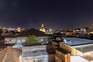 a view of a city skyline at night at Saint Jacob Hotel in Nazareth
