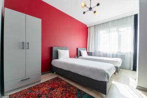 twee bedden in een kamer met rode muren bij Hexa Suites Hotel in Istanbul +185 foto's