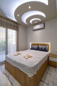 a bedroom with a large bed with two pillows on it at Sergio Luxury Appartment in Nea Potidaea