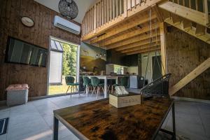 a room with a table and a kitchen with a staircase at Łąckie Zacisze in Łącko