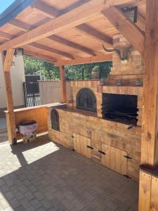 una cocina al aire libre con horno de ladrillo en un patio en GIADDA Rooms, en Borşa