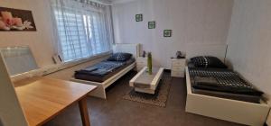 Sala de estar con 2 camas y mesa en Büdingen Hanau Frankfurt en Büdingen