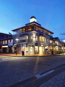 a large building on a city street at night at Apartment at Hermanus Waterfront in Hermanus