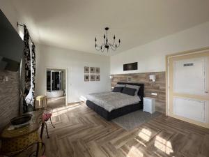 a bedroom with a bed and a chandelier at Schloß Ziegersberg 