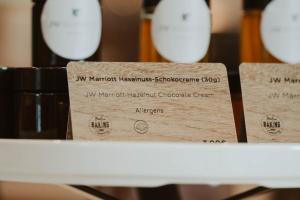 a shelf with two wooden boxes on it with wine glasses at JW Marriott Hotel Berlin in Berlin