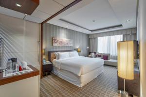 a hotel room with a bed and a living room at Majestic Premier Hotel Burdubai in Dubai +31 photos