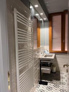 a bathroom with a sink and a shower at Casa Cavour in Montecatini Terme