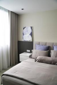 Un dormitorio con una cama grande y una ventana en Modern & Minimalist 2-Bedroom Apartment in PJ en Petaling Jaya