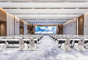 a large room with rows of tables and chairs at EVEN Hotels Shenzhen Guangming Cloud Park, an IHG Hotel in Shenzhen