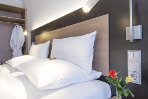 Postel nebo postele na pokoji v ubytování Astor & Aparthotel