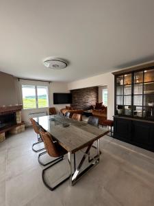 a large living room with a table and chairs at AU COEUR DU TERROIR CHAMPENOIS in Chavot-Courcourt