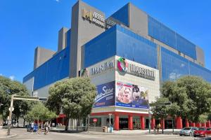 a large blue building on the corner of a street at Apartment Centropolis in Mostar