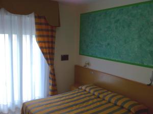 Postel nebo postele na pokoji v ubytování Hotel Altinate