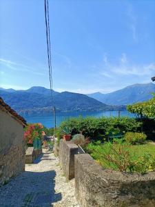 a walkway with a view of a body of water at casa Virginia nel borgo in Lierna