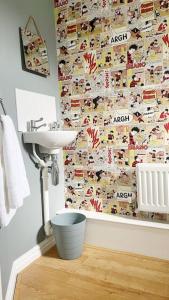 a bathroom with a sink and a wall covered in magnets at Witton House by Blue Skies Stays in Stockton-on-Tees