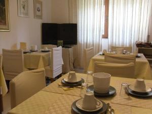 comedor con mesas y sillas y TV en B&B Fragus e Saboris de Sardigna, en Sadali