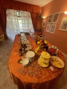 una mesa larga con muchos platos de comida. en Hotel Villa Leri, en Monte Colombo