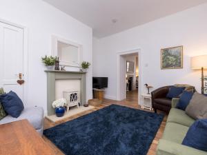 a living room with a couch and a fireplace at Pass the Keys Stylish apartment in Central Bath in Bath