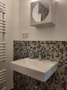 a white sink in a bathroom with a mirror at Artist Studio - Berlin - Prenzlauer Berg in Berlin
