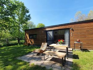 a picnic table and chairs in front of a cabin at Lavečka u Valtic in Valtice