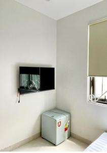 a room with a small refrigerator and a window at Crabby homes in Hanoi +9 photos